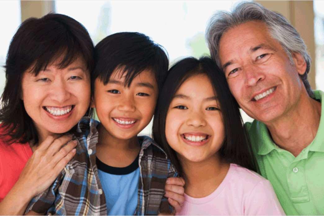 Asian family with two kids smiling