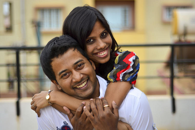 Indian couple smiling - by Flickr User MyNameIsHarsha