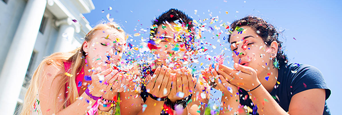 Three Cal students with confetti at Sproul